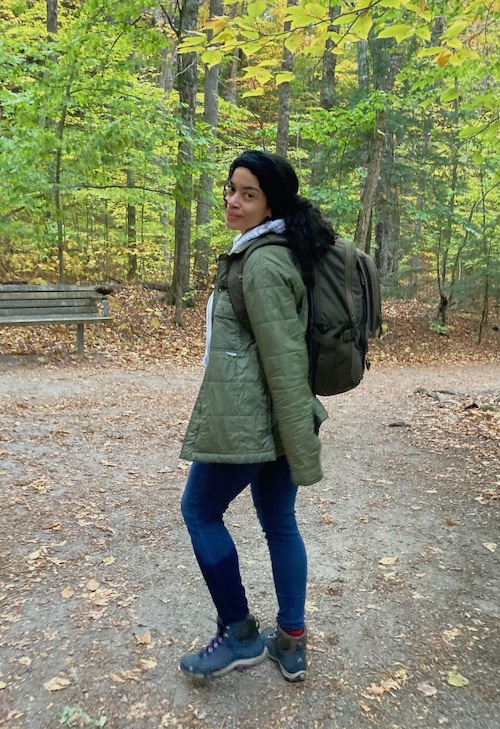 Women in hiking clothing in a green forest looking back